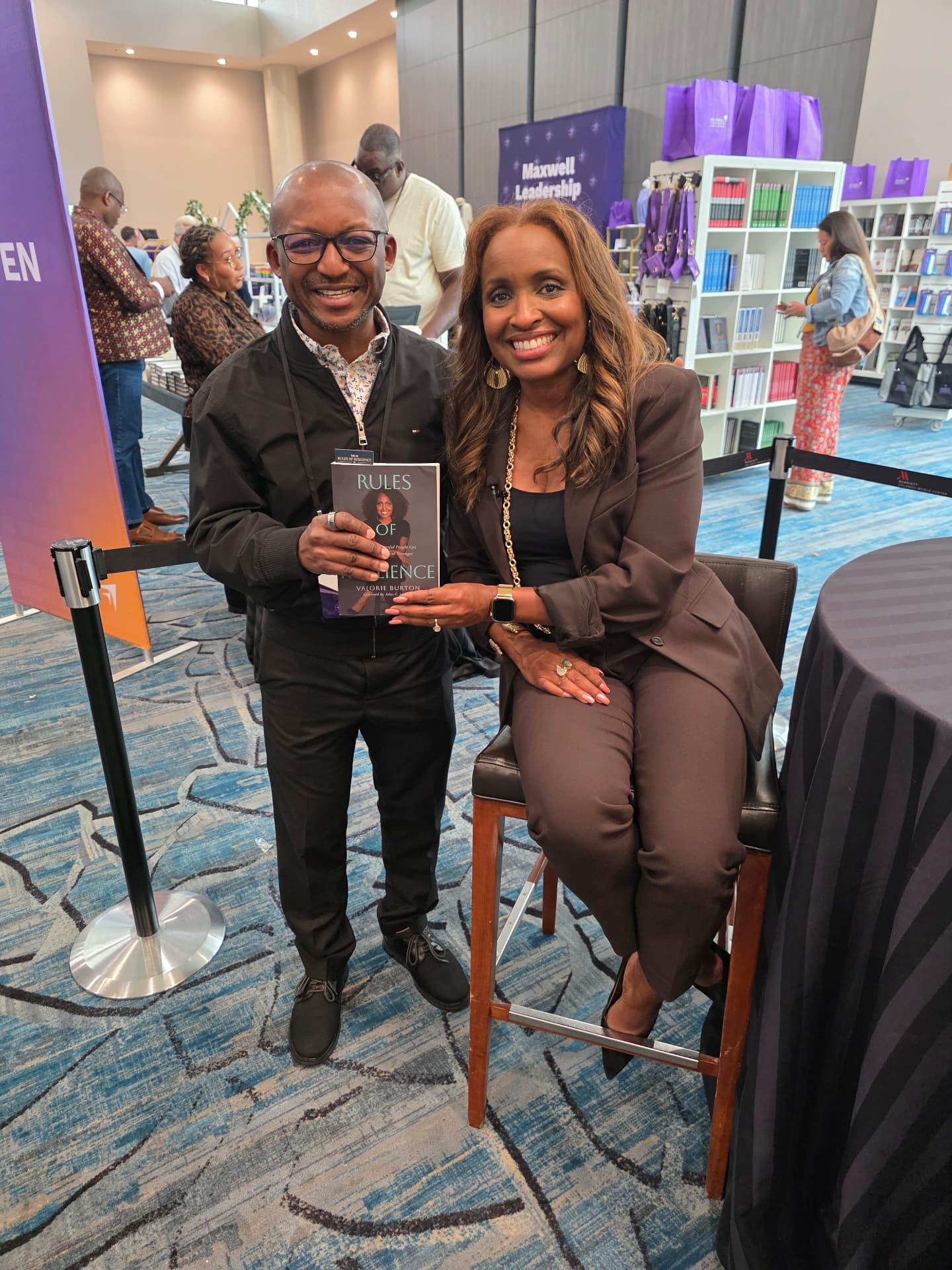 Nene with author Valorie Burton holding her book Rules of Resilience