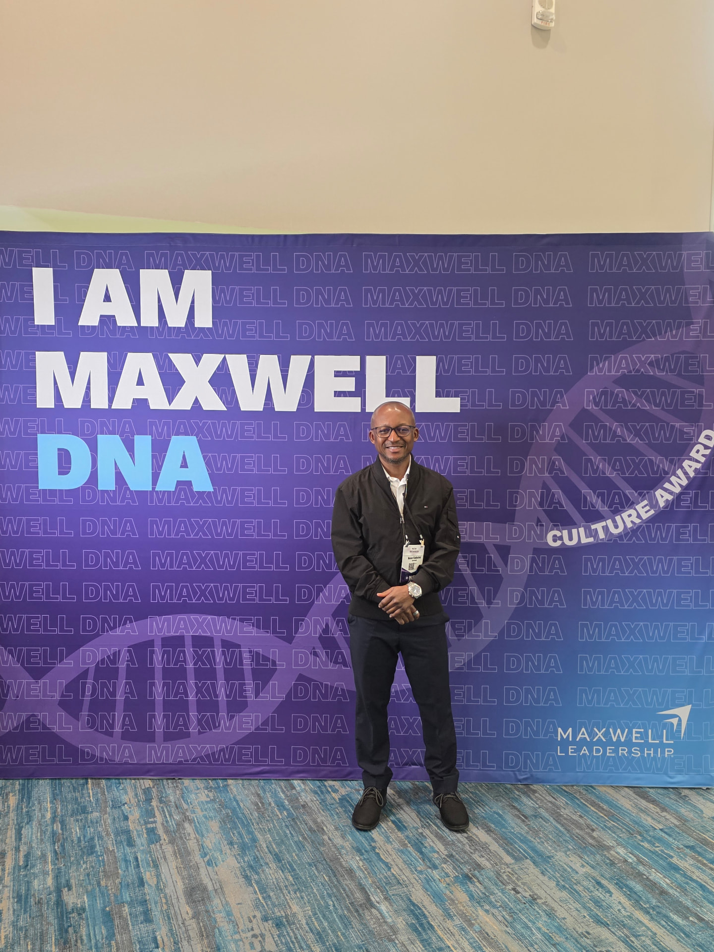 Nene in front of the 'I Am Maxwell DNA' banner